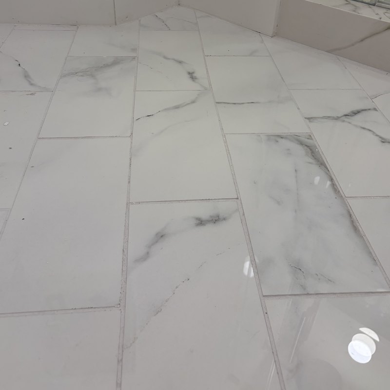 Large-format porcelain floor tile running out from the shower.